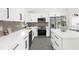 Modern kitchen with white cabinets, stainless steel appliances, and an island at 4467 Cinderella Cir, North Port, FL 34286