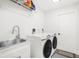 Laundry room with washer, dryer, and utility sink at 4467 Cinderella Cir, North Port, FL 34286