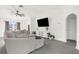 Bright living room with gray sectional sofa, large TV, and tile floors at 4467 Cinderella Cir, North Port, FL 34286