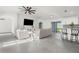 Open and bright living room with gray sectional sofa and kitchen view at 4467 Cinderella Cir, North Port, FL 34286