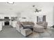 Open-concept living room and kitchen with gray sectional and island at 4467 Cinderella Cir, North Port, FL 34286