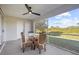 Screened porch with glass-top table and wicker chairs at 4467 Cinderella Cir, North Port, FL 34286