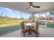 Screened porch with glass-top table and wicker chairs at 4467 Cinderella Cir, North Port, FL 34286