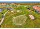 Drone view of the golf course and surrounding neighborhood at 4665 Whispering Oaks Dr, North Port, FL 34287