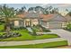 One-story home with tile roof, landscaping, and two-car garage at 5019 Bella Terra Dr, Venice, FL 34293