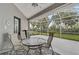 Spacious screened-in porch with seating area and ceiling fan at 5019 Bella Terra Dr, Venice, FL 34293