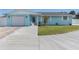 Front view of a light blue house with a two-car garage at 5032 Linda St, Venice, FL 34293