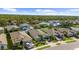 Aerial view of a residential neighborhood showcasing houses, landscaping, and a tree line at 5230 Canyonland Way, Venice, FL 34293