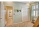 Light teal bedroom with double doors and a view of the hallway at 5230 Canyonland Way, Venice, FL 34293