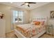 Bright bedroom with a queen bed and window with plantation shutters at 5230 Canyonland Way, Venice, FL 34293