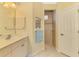 Bathroom with double vanity, shower, and linen closet at 5633 Whispering Oaks Dr, North Port, FL 34287