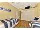 Guest bedroom with twin beds, ample closet space, and wood-look floors at 5633 Whispering Oaks Dr, North Port, FL 34287