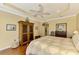 King-size bed in a well-lit bedroom with hardwood floors at 5633 Whispering Oaks Dr, North Port, FL 34287