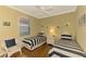 Guest bedroom with twin beds and hardwood floors at 5633 Whispering Oaks Dr, North Port, FL 34287