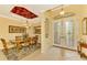 Bright dining room with a wood table and chairs, decorative ceiling, and access to the foyer at 5633 Whispering Oaks Dr, North Port, FL 34287