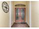 Elegant entryway with double doors and decorative iron wall art at 5633 Whispering Oaks Dr, North Port, FL 34287