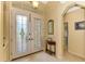 Bright entryway with double doors, tile flooring, and access to bathroom at 5633 Whispering Oaks Dr, North Port, FL 34287