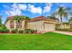 Single-story home with red tile roof, brick driveway, and landscaped yard at 5633 Whispering Oaks Dr, North Port, FL 34287