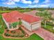 Single-story home with red tile roof, brick driveway, and landscaped yard at 5633 Whispering Oaks Dr, North Port, FL 34287