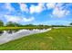 Serene golf course view with water feature at 5633 Whispering Oaks Dr, North Port, FL 34287
