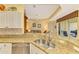 Kitchen features granite countertops and a double sink at 5633 Whispering Oaks Dr, North Port, FL 34287