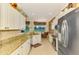 Modern kitchen with stainless steel appliances and granite counters at 5633 Whispering Oaks Dr, North Port, FL 34287