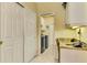 Laundry room with washer, dryer, and built-in desk at 5633 Whispering Oaks Dr, North Port, FL 34287