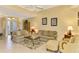 Relaxing living room with ample seating, neutral tones, and a view of the entryway at 5633 Whispering Oaks Dr, North Port, FL 34287