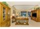 Spacious living room with large windows, comfortable seating, and an inviting atmosphere at 5633 Whispering Oaks Dr, North Port, FL 34287