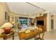Elegant living room with a view of the golf course from the sliding glass door at 5633 Whispering Oaks Dr, North Port, FL 34287