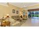 Comfortable living room with a view of the golf course and neutral color palette at 5633 Whispering Oaks Dr, North Port, FL 34287