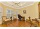 Home office with built-in cabinetry and hardwood floors at 5633 Whispering Oaks Dr, North Port, FL 34287
