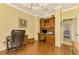 Home office with hardwood floors and built-in shelving at 5633 Whispering Oaks Dr, North Port, FL 34287
