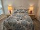 Serene bedroom with a decorative bedspread, side tables, and lamps that create a peaceful ambiance at 606 Marcus St # 26, Venice, FL 34285