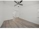 Spacious bedroom with wood floors, ceiling fan, and access to the ensuite bathroom at 606 Marcus St # 26, Venice, FL 34285