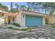 Charming villa featuring a tile roof and a two-car garage door painted light blue at 606 Marcus St # 26, Venice, FL 34285