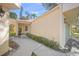 Updated condo with light beige exterior and teal garage door at 606 Marcus St # 26, Venice, FL 34285