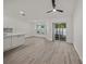 Bright living room features wood-look floors and sliding glass doors to a patio at 606 Marcus St # 26, Venice, FL 34285