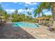 Refreshing community pool surrounded by palm trees and patio furniture at 606 Marcus St # 26, Venice, FL 34285