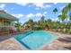 Sparkling community pool and patio area with lounge chairs at 606 Marcus St # 26, Venice, FL 34285