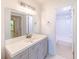 Modern bathroom with gray vanity, white countertop, and a shower/tub combo at 612 Bird Bay S Dr # 114, Venice, FL 34285