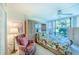 Bright bedroom with a floral bedspread, large window, and built-in wardrobe at 612 Bird Bay S Dr # 114, Venice, FL 34285