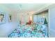Spacious bedroom with a floral bedspread and ensuite bathroom access at 612 Bird Bay S Dr # 114, Venice, FL 34285
