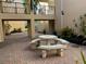 Inviting courtyard with stone table and benches at 612 Bird Bay S Dr # 114, Venice, FL 34285