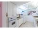 Efficient kitchen with granite counters and white cabinets at 612 Bird Bay S Dr # 114, Venice, FL 34285
