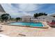 Community pool with lounge chairs and surrounding patio at 618 Circlewood Dr # S2-15, Venice, FL 34293