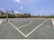 Outdoor basketball court with multiple hoops and surrounding trees at 669 Alligator Dr, Venice, FL 34293