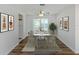 Dining room with wood-look floors, a table with seating for six, and sliding glass doors at 669 Alligator Dr, Venice, FL 34293