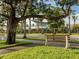 Tree-lined street with bench and shops in Venice at 669 Alligator Dr, Venice, FL 34293