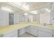 Large bathroom with double vanity and mirrored walls at 6906 Woodwind Dr # 12, Sarasota, FL 34231